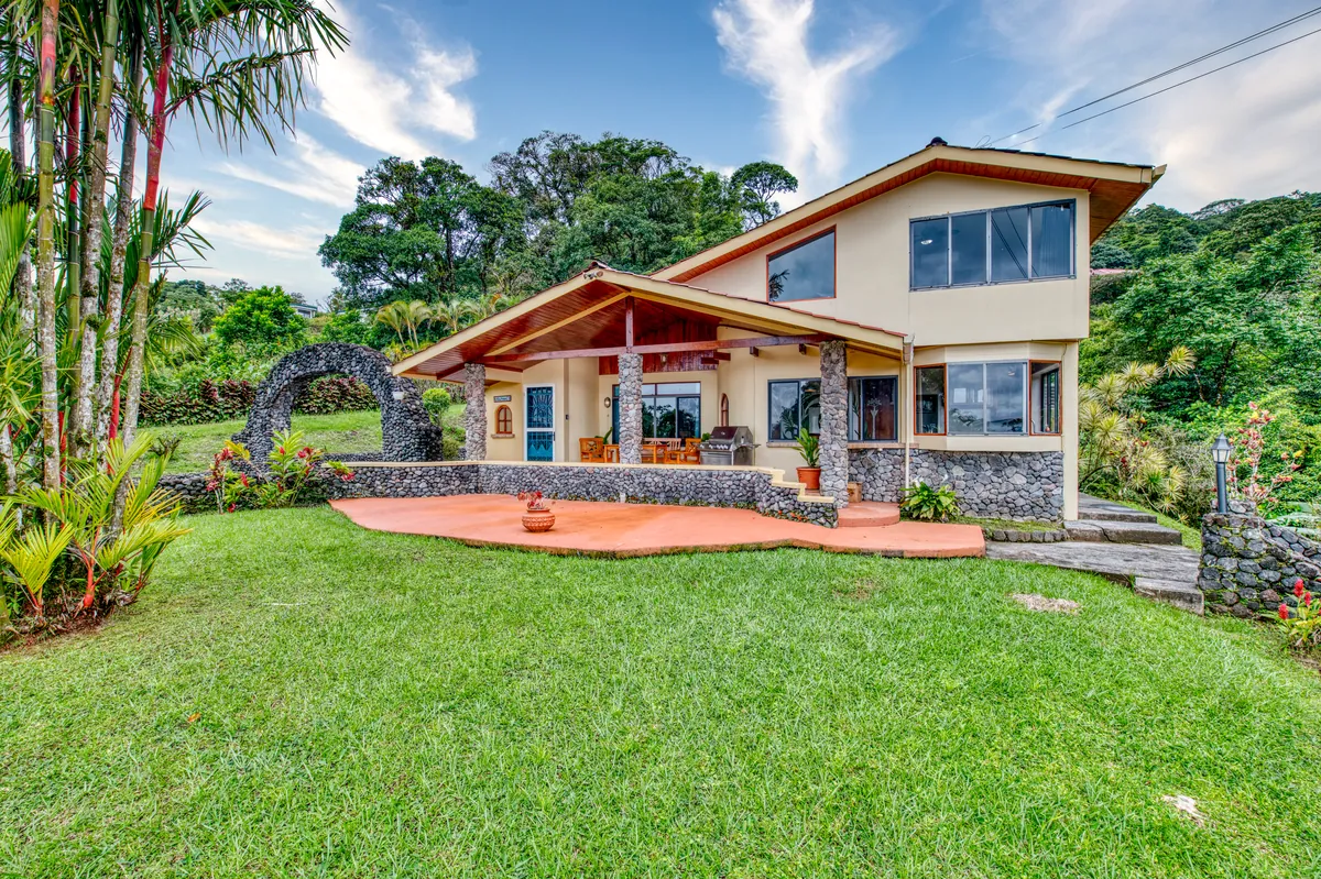 Casa Primera, a two-story villa with a stone arch and terrace at Elements